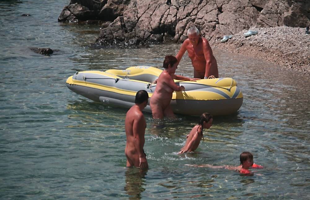 Lone Nudist in Yellow Boat photos - The lifestyle of naturist advocates and their community