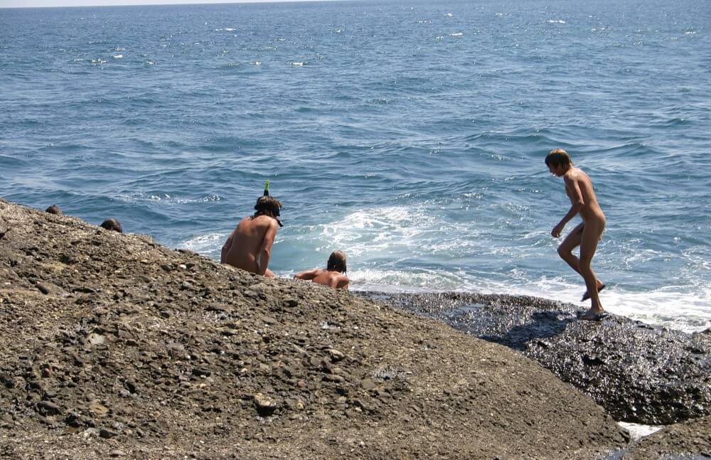 Leaning Against Hit Rocks pics - Naturism promotes tolerance